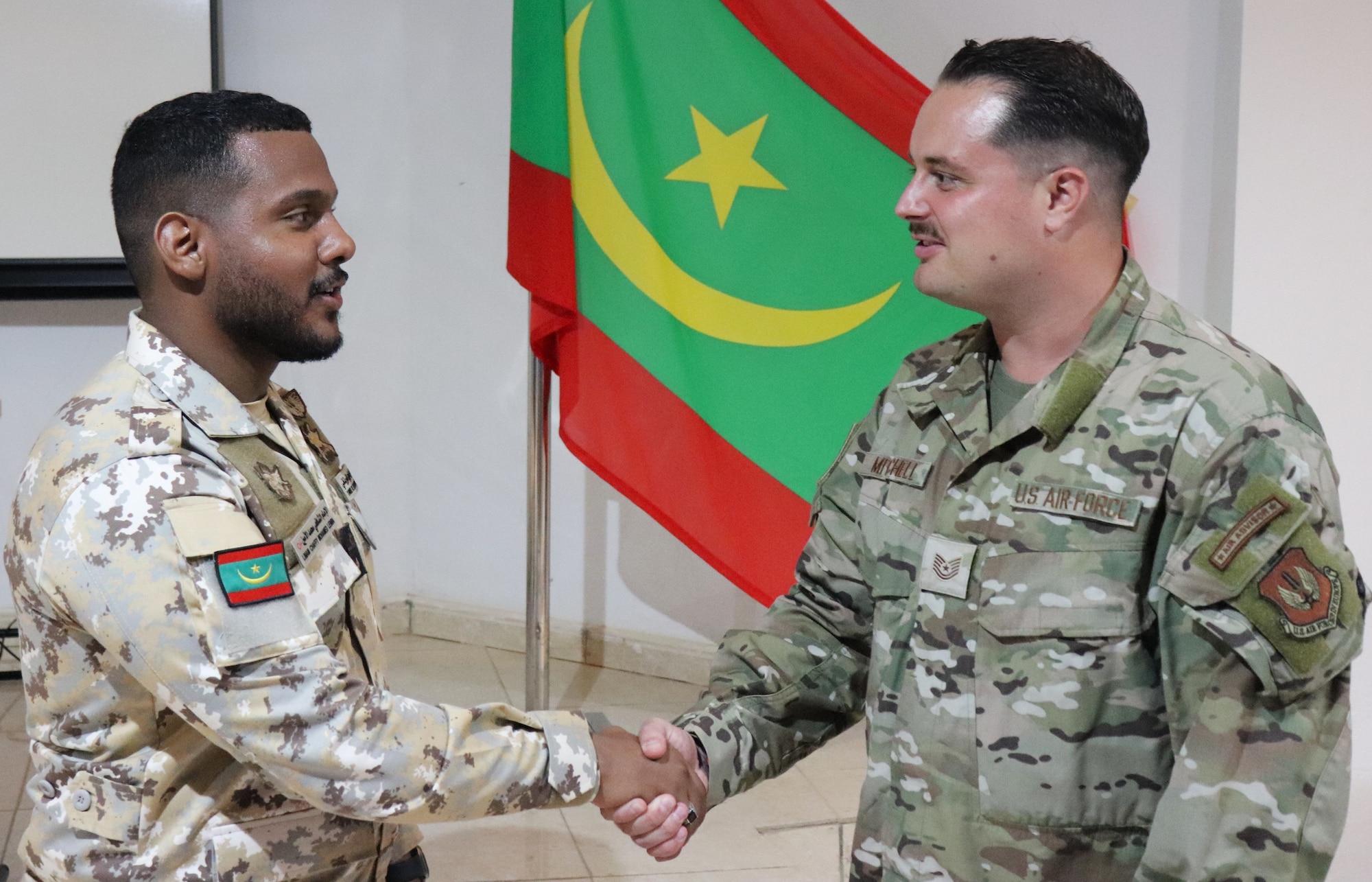 Mauritanian Air Force 2nd Lt. Limam Chaffy Mohamed Lemin, sensor operator, meets U.S. Air Force Technical Sgt. Andrej Mitchel, 435th Tactical Operations Squadron section chief of standardization and evaluation
