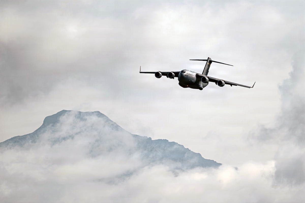 A C-17 Globemaster III assigned to the Air Force C-17 Demonstration Team at Joint Base Pearl Harbor-Hickam, Hawaii, performs during the Arctic Thunder Open House at Joint Base Elmendorf-Richardson, Alaska, Aug. 8, 2026. The C-17 provides rapid strategic delivery of personnel and cargo to main operating bases and forward locations. (U.S. Air National Guard photo by Staff Sgt. Joseph Moon)
