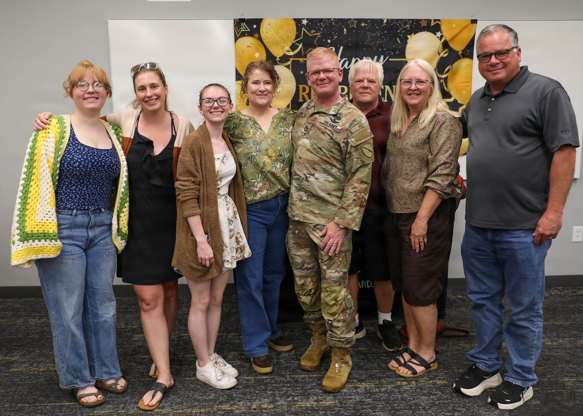 U.S. Army Sgt. 1st Class Jeremy Lowe poses for a photo with his wife, parents, daughter and extended family after his retirement ceremony at Joint Force Headquarters on Boone National Guard Center in Frankfort, Kentucky, July 29, 2026.