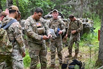 New York Air National Guardsmen assigned to 107th Security Forces squadron begin to set coordinates for their next checkpoint during a land navigation exercise at Joint Base Elmendorf-Richarson, Alaska, July 16, 2026.