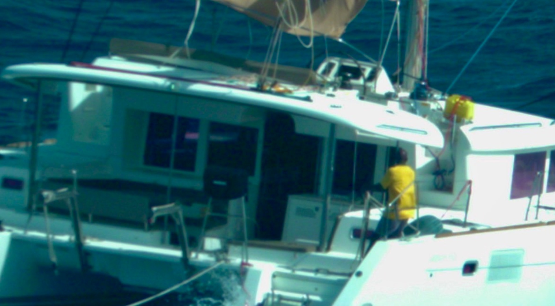 Photo taken by U.S. Coast Guard Air Station Miami HC-144 Ocean Sentry aircrew of an overdue sailing catamaran and Peter Baron shortly before his rescue by a Dutch Coast Guard marine unit, approximately 11 nautical miles west of Sint Maarten, Aug.13, 2026.  “I am incredibly proud of our Coast Guard servicemembers and commend the phenomenal efforts of our French, Dutch, and Virgin Islands partners, which ensured this mariner’s safe return to his family,” said Cmdr. Matthew Romano, Coast Guard Search and Rescue mission coordinator for the case. (U.S. Coast Guard photo)