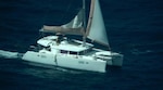 Photo taken by U.S. Coast Guard Air Station Miami HC-144 Ocean Sentry aircrew of an overdue sailing catamaran and Peter Baron shortly before his rescue by a Dutch Coast Guard marine unit, approximately 11 nautical miles west of Sint Maarten, Aug.13, 2026.  “I am incredibly proud of our Coast Guard servicemembers and commend the phenomenal efforts of our French, Dutch, and Virgin Islands partners, which ensured this mariner’s safe return to his family,” said Cmdr. Matthew Romano, Coast Guard Search and Rescue mission coordinator for the case. (U.S. Coast Guard photo)