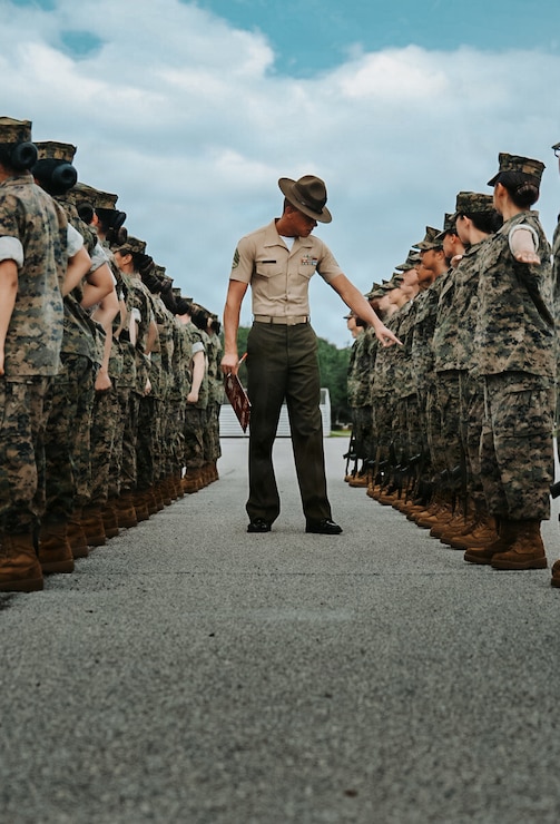 U.S. Marine Corps Staff Sgt. Reece Frye, a drill master with Recruit Training Regiment, evaluates recruits during final drill on Marine Corps Recruit Depot Parris Island, S.C., Aug. 8, 2026. Final Drill tests drill instructors on their ability to give drill commands and tests recruits on their ability to execute the movements properly. 