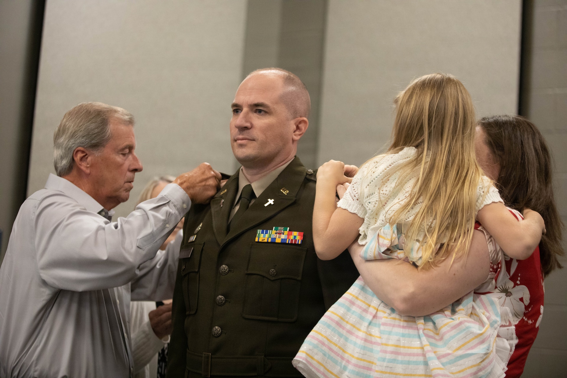 U.S. Army Lt. Col. Eric Honeycutt is pinned with his new rank by his father, Bill Honeycutt, and his wife and daughter, Allison and Kaiyah, during a ceremony at Boone National Guard Center in Frankfort, June 24. Family, friends and fellow Soldiers gathered for the ceremony. (U.S. Army National Guard photo by Milt Spalding)