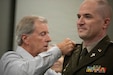 U.S. Army Lt. Col. Eric Honeycutt is pinned with his new rank by his father, Bill Honeycutt, during a ceremony at Boone National Guard Center in Frankfort, June 24. Family, friends and fellow Soldiers gathered for the ceremony. (U.S. Army National Guard photo by Milt Spalding)
