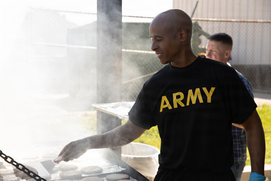 U.S. Army Maj. Gregory Granderson cooks in preparation of a cookout in honor of the Kentucky National Guard’s 234th birthday at Boone National Guard Center in Frankfort, June 24. Soldiers, Airmen and civilians gathered to celebrate the organization's longstanding tradition of service to the Commonwealth and nation and continued commitment to homeland defense, emergency response and warfighting readiness. (U.S. Army National Guard photo by Milt Spalding)