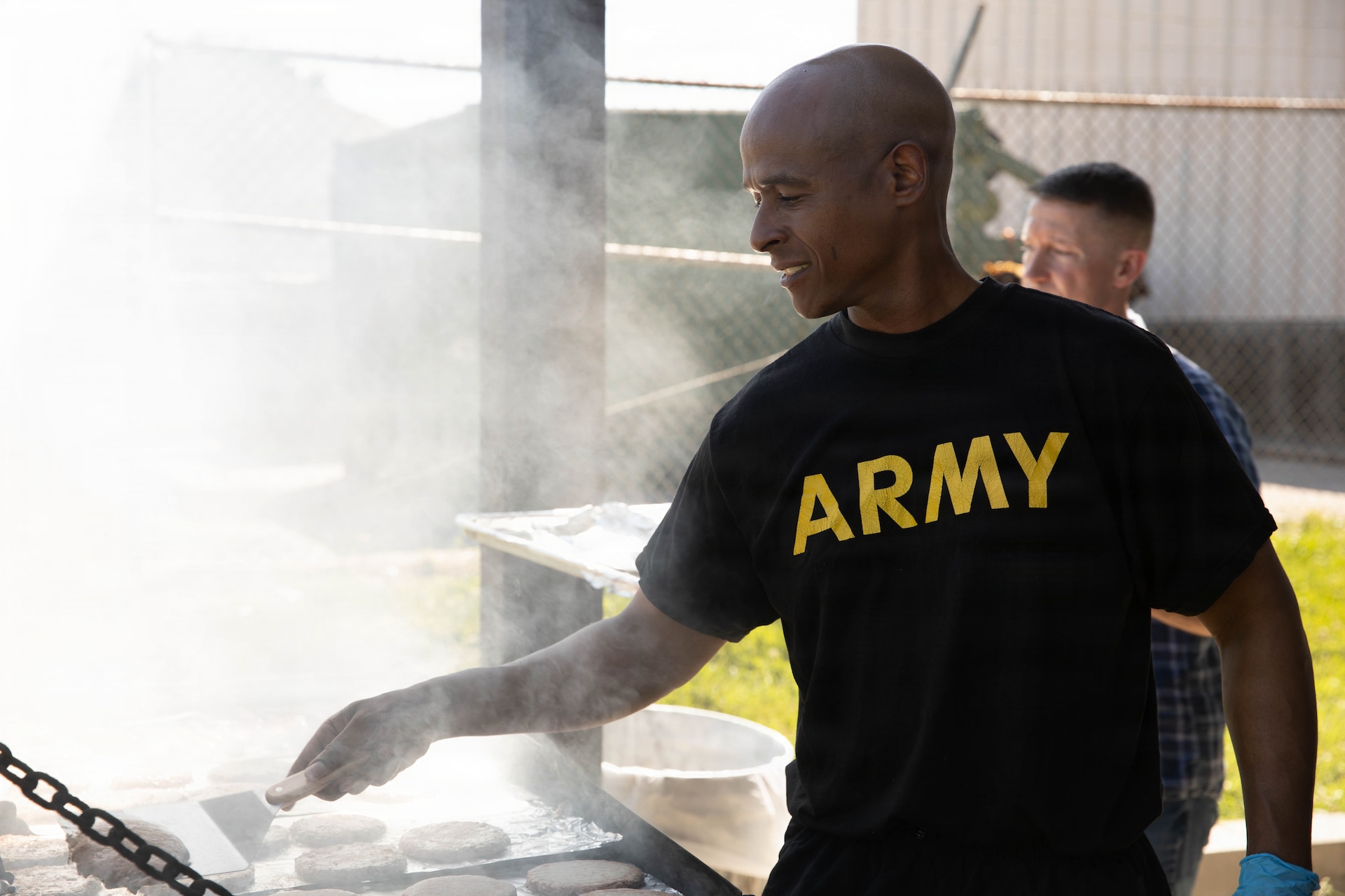 U.S. Army Maj. Gregory Granderson cooks in preparation of a cookout in honor of the Kentucky National Guard’s 234th birthday at Boone National Guard Center in Frankfort, June 24. Soldiers, Airmen and civilians gathered to celebrate the organization's longstanding tradition of service to the Commonwealth and nation and continued commitment to homeland defense, emergency response and warfighting readiness. (U.S. Army National Guard photo by Milt Spalding)