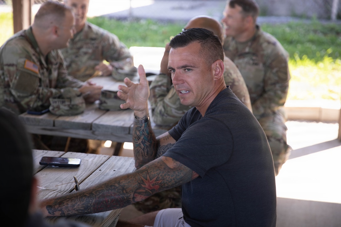 U.S. Army Maj. Joshua Pitcher talks with fellow Soldiers during a cookout in honor of the Kentucky National Guard’s 234th birthday at Boone National Guard Center in Frankfort, June 24. Soldiers, Airmen and civilians gathered to celebrate the organization's longstanding tradition of service to the Commonwealth and nation and continued commitment to homeland defense, emergency response and warfighting readiness. (U.S. Army National Guard photo by Milt Spalding)