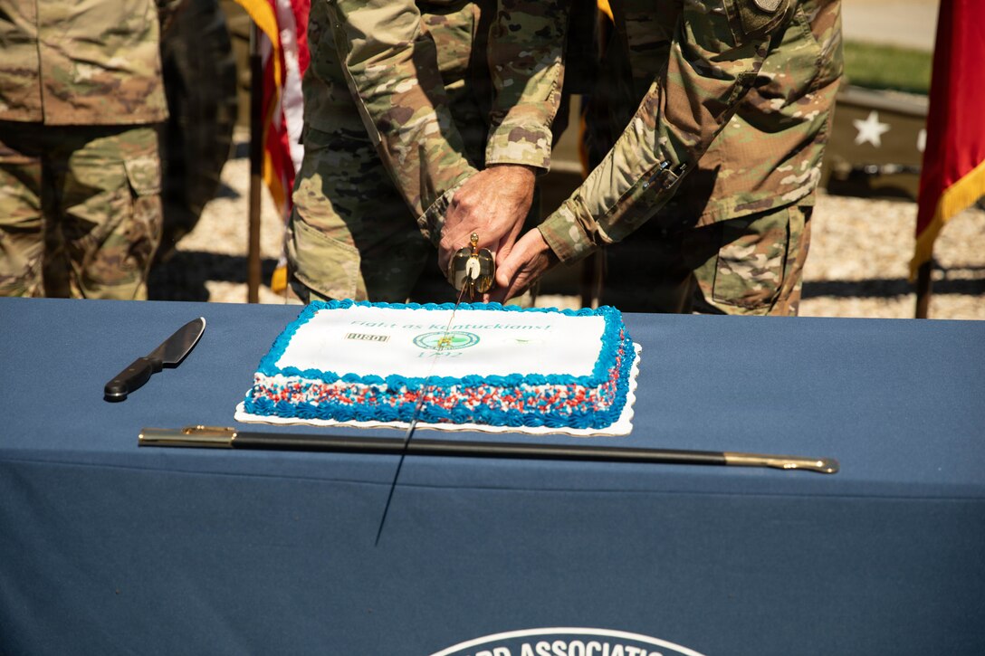 U.S. Army Sgt. Colin Daniel, the youngest Soldier in attendance, and Brig. Gen. Brian Wertzler participate in a ceremonial cake-cutting during a birthday celebration at Boone National Guard Center in Frankfort, June 24. The tradition symbolizes the passing of knowledge, experience and service from one generation of Guardsmen to the next while commemorating the Kentucky National Guard's history of service to the Commonwealth and nation. (U.S. Army National Guard photo by Milt Spalding)