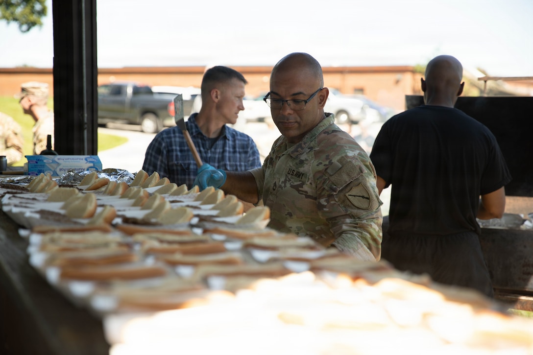 U.S. Army Sgt. 1st Class Benjamin Martinez prepares food for a cookout in honor of the Kentucky National Guard’s 234th birthday at Boone National Guard Center in Frankfort, June 24. Soldiers, Airmen and civilians gathered to celebrate the organization's longstanding tradition of service to the Commonwealth and nation and continued commitment to homeland defense, emergency response and warfighting readiness. (U.S. Army National Guard photo by Milt Spalding)