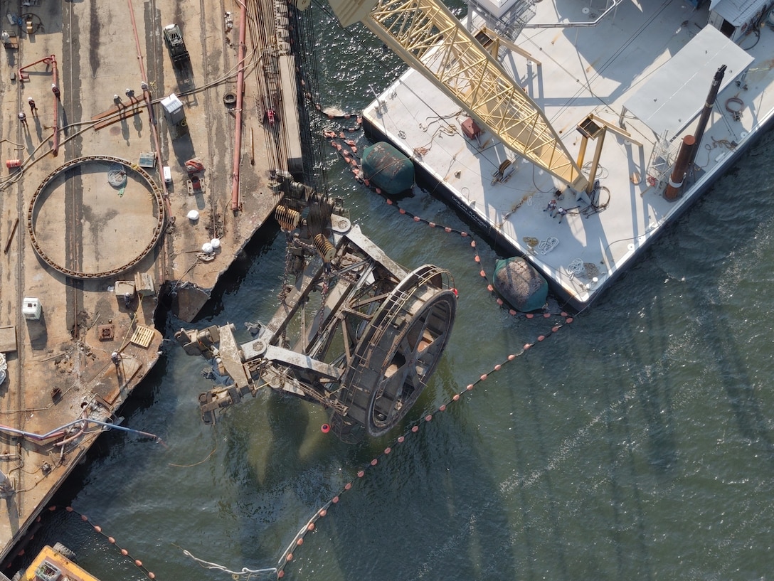The final piece of a submerged crane is removed from the Cooper River at Pier G in Charleston, South Carolina, July 30, 2026. The U.S. Coast Guard oversaw salvage operations to protect the marine environment and restore the waterway, working with port partners and a contracted salvage company to remove the crane after it fell into the river on July 10. (U.S. Coast Guard photo by Petty Officer 3rd Class Lucas Braun)