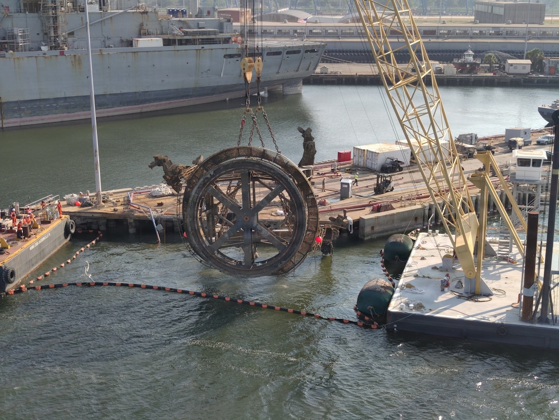 The final piece of a submerged crane is removed from the Cooper River at Pier G in Charleston, South Carolina, July 30, 2026. The U.S. Coast Guard oversaw salvage operations to protect the marine environment and restore the waterway, working with port partners and a contracted salvage company to remove the crane after it fell into the river on July 10. (U.S. Coast Guard photo by Petty Officer 3rd Class Lucas Braun)