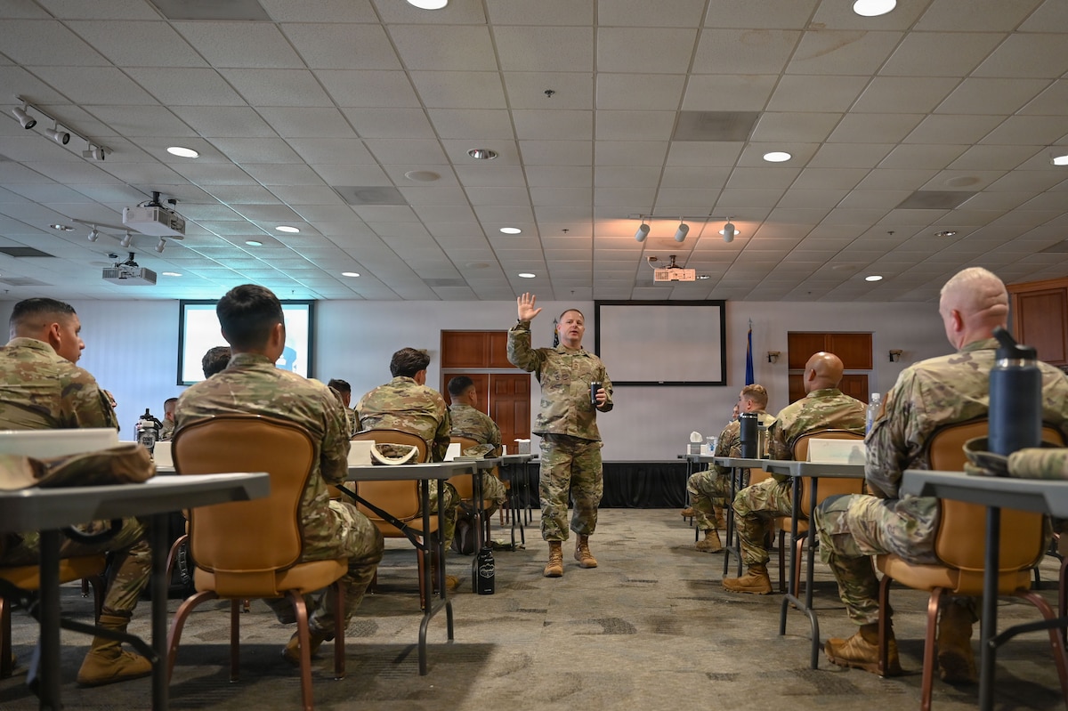 U.S. Air Force Chief Master Sgt. Vincent Lopez, 12th Air Force (Air Forces Southern) senior enlisted leader and class mentor for the Senior Enlisted Noncommissioned Officer Professional Enhancement Seminar, asks students a question during his class introduction at Davis-Monthan Air Force Base, Arizona, Aug. 3, 2026. Lopez discussed how challenging it can be to transition from the tactical to strategic level without deliberate development and mentorship opportunities – emphasizing the need to bring clear cut solutions, team unification and development, as well as skills for leading with a servant mindset. (U.S. Air Force photo by Staff Sgt. Kahdija Slaughter)