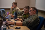 U.S. Air Force members assigned to the 217th Air Component Operations Squadron collaborate in support of Exercise Northern Strike 26-2 at Alpena Combat Readiness Training Center, Michigan, Aug. 4, 2026. Northern Strike is a reserve component training event that focuses on joint readiness training to build interoperability and strengthen partnerships between services. Photo by Staff Sgt. Sean Moriarty.
