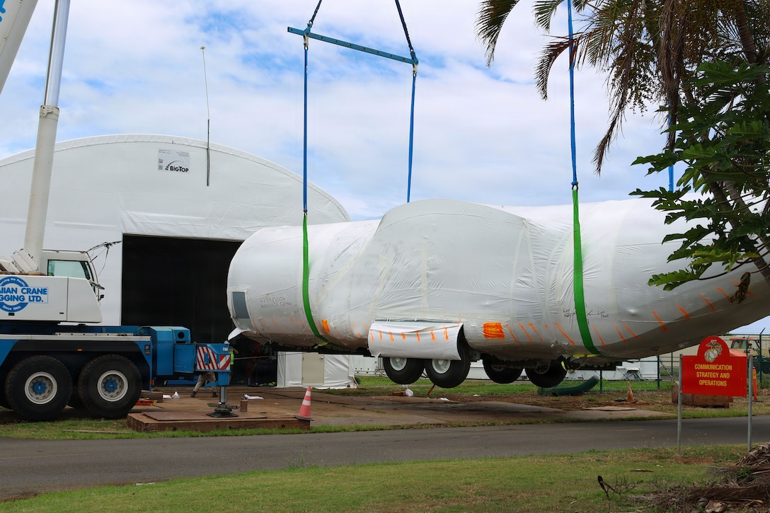 A KC-130J Fuselage Trainer is placed in a hangar at Marine Corps Base Hawaii, Aug. 4, 2026. Marine Aviation Training System Site Kaneohe Bay, 1st Marine Aircraft Wing, received its first KC-130J fuselage trainer from Lockheed Martin. The FuT prepares aircrew for the full range of KC-130J missions without the operational Burden of flying the actual aircraft. (U.S. Marine Corps photo by Sgt. Anabelle Reed-O’Brien)