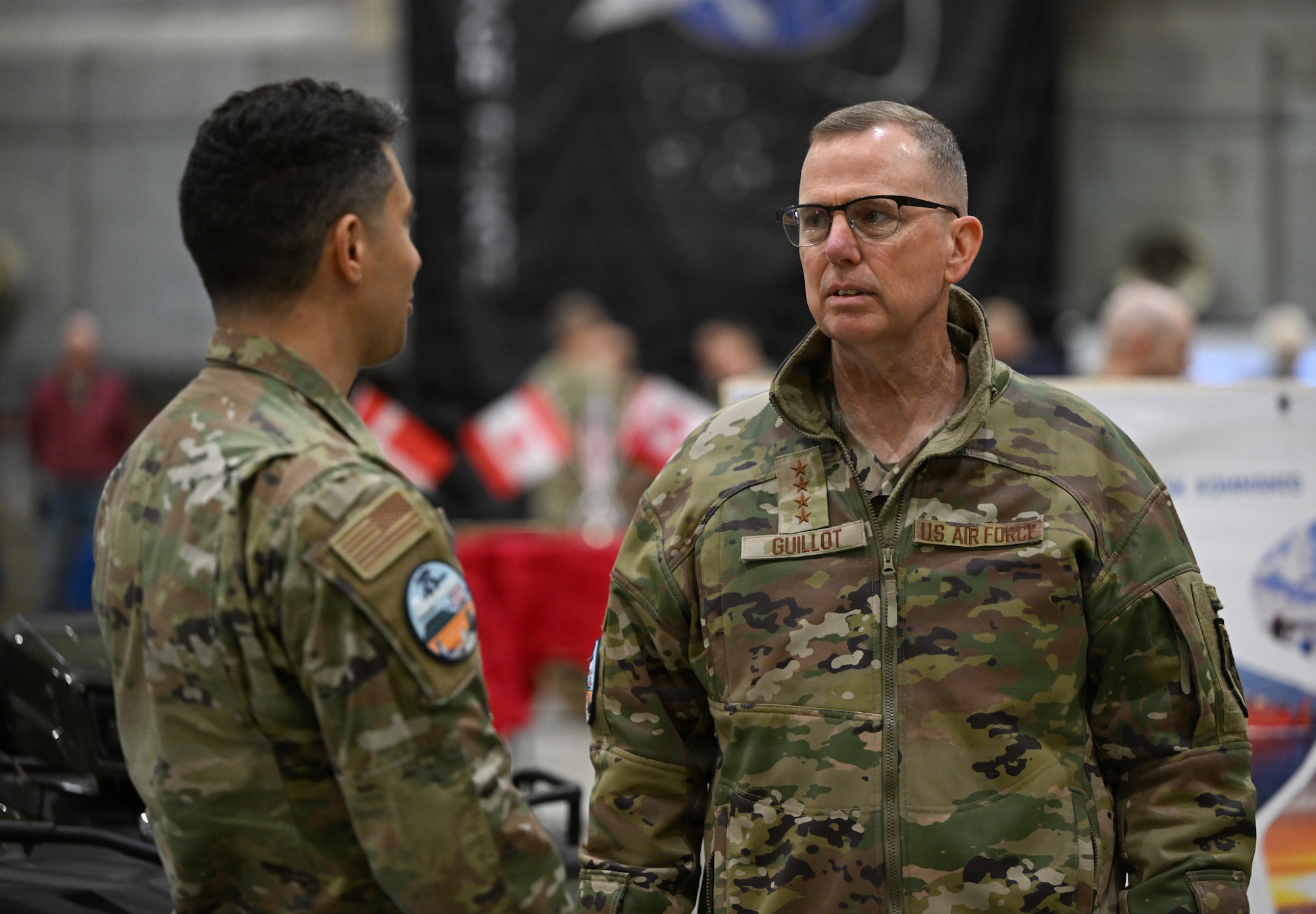 U.S. Air Force Gen. Gregory Guillot, U.S. Northern Command and North American Aerospace Defense Command commander, speaks with Senior Airman Nicolas Calero, 821st Support Squadron member at Pituffik SB Aug. 12, 2026.