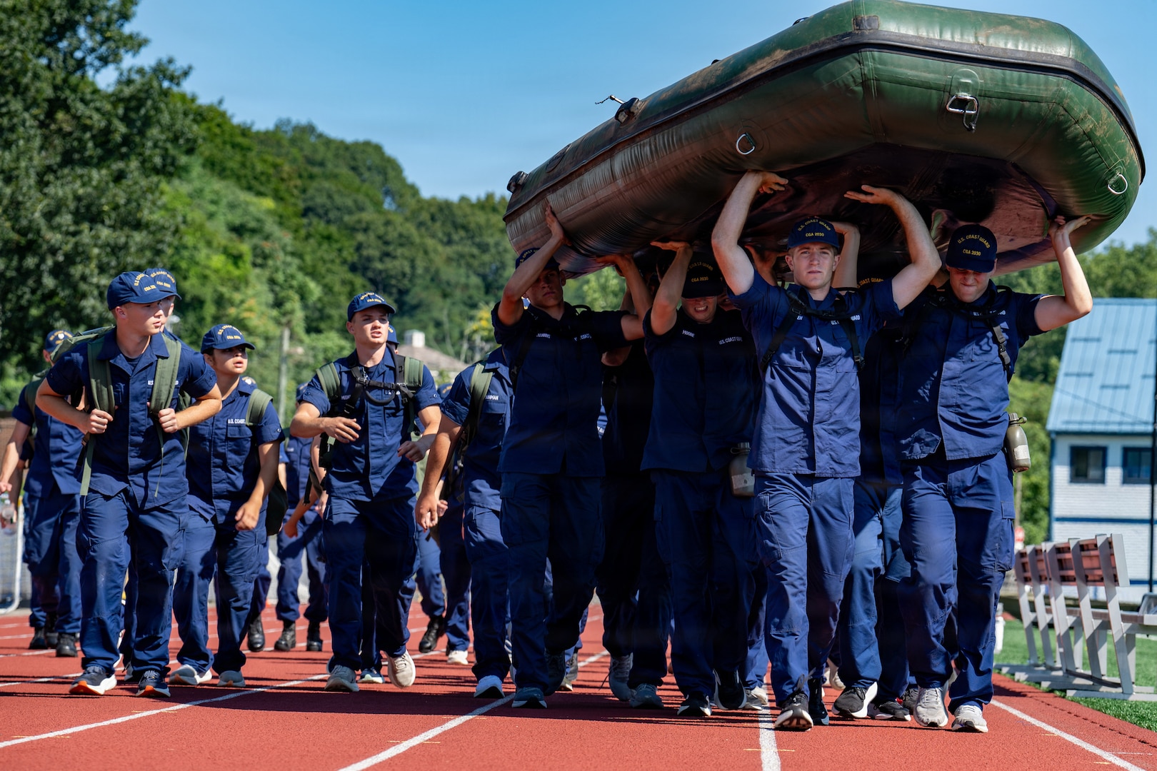 U.S. Coast Guard Cadets carry a boat during sea trials at the Academy, New London, Conn., Aug. 14, 2026. The daylong event tests swabs physical endurance, mental resilience and teamwork as they complete their summer training program.(U.S. Coast Guard photo by Petty Officer 3rd Class Roxanna Jacobo Cruz)