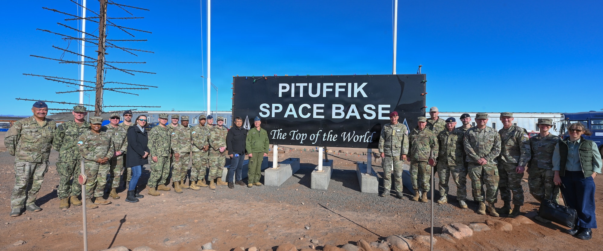 Dignitaries from the United States, Canada, the Kingdom of Denmark and Greenland pose for a photo outside the 821st Space Base Group headquarters building during the 75 Anniversary of Pituffik Space Base at Pituffik SB, Greenland, Aug. 12, 2026.
