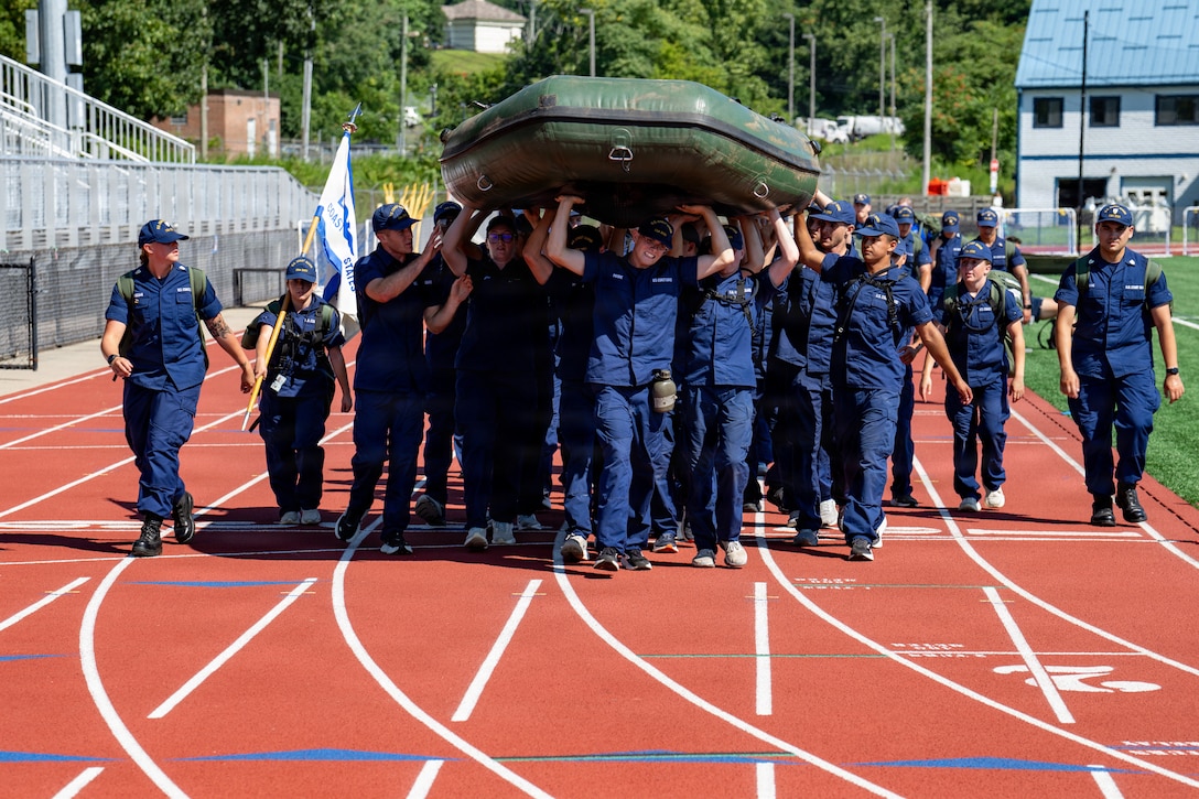 U.S. Coast Guard Cadets carry a boat during sea trials at the Academy, New London, Conn., Aug. 14, 2026. The daylong event tests swabs physical endurance, mental resilience and teamwork as they complete their summer training program.(U.S. Coast Guard photo by Petty Officer 3rd Class Roxanna Jacobo Cruz)