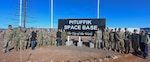 Dignitaries from the United States, Canada, the Kingdom of Denmark and Greenland pose for a photo outside the 821st Space Base Group headquarters building during the 75 Anniversary of Pituffik Space Base at Pituffik SB, Greenland, Aug. 12, 2026.