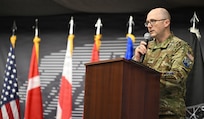 U.S. Space Force Col. Shawn Lee, 821st Space Base Group outgoing commander, gives closing remarks at the Pituffik Space Base 75th anniversary at Pituffik SB, Greenland, Aug. 12, 2026