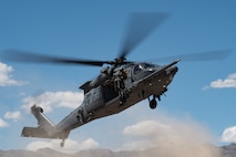 U.S. Air Force Staff Sgt. Devon Curtis, a special missions aviator assigned to Detachment 1, 413th Flight Test Squadron, looks out of an HH-60W Jolly Green II assigned to the 88th Test and Evaluation Squadron, during an operational test and training mission, April 29, 2025. Recently on Aug. 10, 2026, the 88 TES rapidly generated and deployed two HH-60W Jolly Green II helicopters to rescue five U.S. Navy personnel following an aircraft mishap near Naval Air Weapons Station China Lake, California. (U.S. Air Force photo by Staff Sgt. Jose Miguel T. Tamondong)