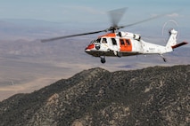 An Air Test and Evaluation Squadron (VX) 31 MH-60S Seahawk flies over mountainous terrain during search and rescue training at Naval Air Weapons Station China Lake, California, June 15, 2026. VX-31's search and rescue crews train across desert and mountain terrain to sustain readiness for the squadron's developmental flight test mission. (U.S. Navy photo by Michael L. Smith)