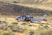 An Air Test and Evaluation Squadron (VX) 31 MH-60S Seahawk sits in high desert brush during search and rescue training at Naval Air Weapons Station China Lake, California, June 15, 2026. VX-31's search and rescue crews train across desert and mountain terrain to sustain readiness for the squadron's developmental flight test mission. (U.S. Navy photo by Michael L. Smith)