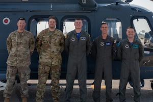Tech. Sgt. Homer Miller, Malmstrom Operational Medical Readiness Squadron flight medicine section chief, Senior Airman Dakota Doss, 40th Helicopter Squadron (HS) special missions aviator, Staff Sgt. Owen Anderson, 40th HS weapons and tactics noncommissioned officer in charge, Capt. Aaron Sanders, 550th HS standards and evaluation officer, and Capt. Jacques Soto, 40th HS MH-139A chief of standards and evaluations, pose for a photo in front of an MH-139A Grey Wolf helicopter at Malmstrom Air Force Base, Montana, Aug. 7, 2026. They crewed Air Force Rescue 11 during the first successful operational use of the MH-139A’s rescue hoist during a search and rescue effort. (U.S. Air Force photo by Tech. Sgt. Aaron Thomasson)