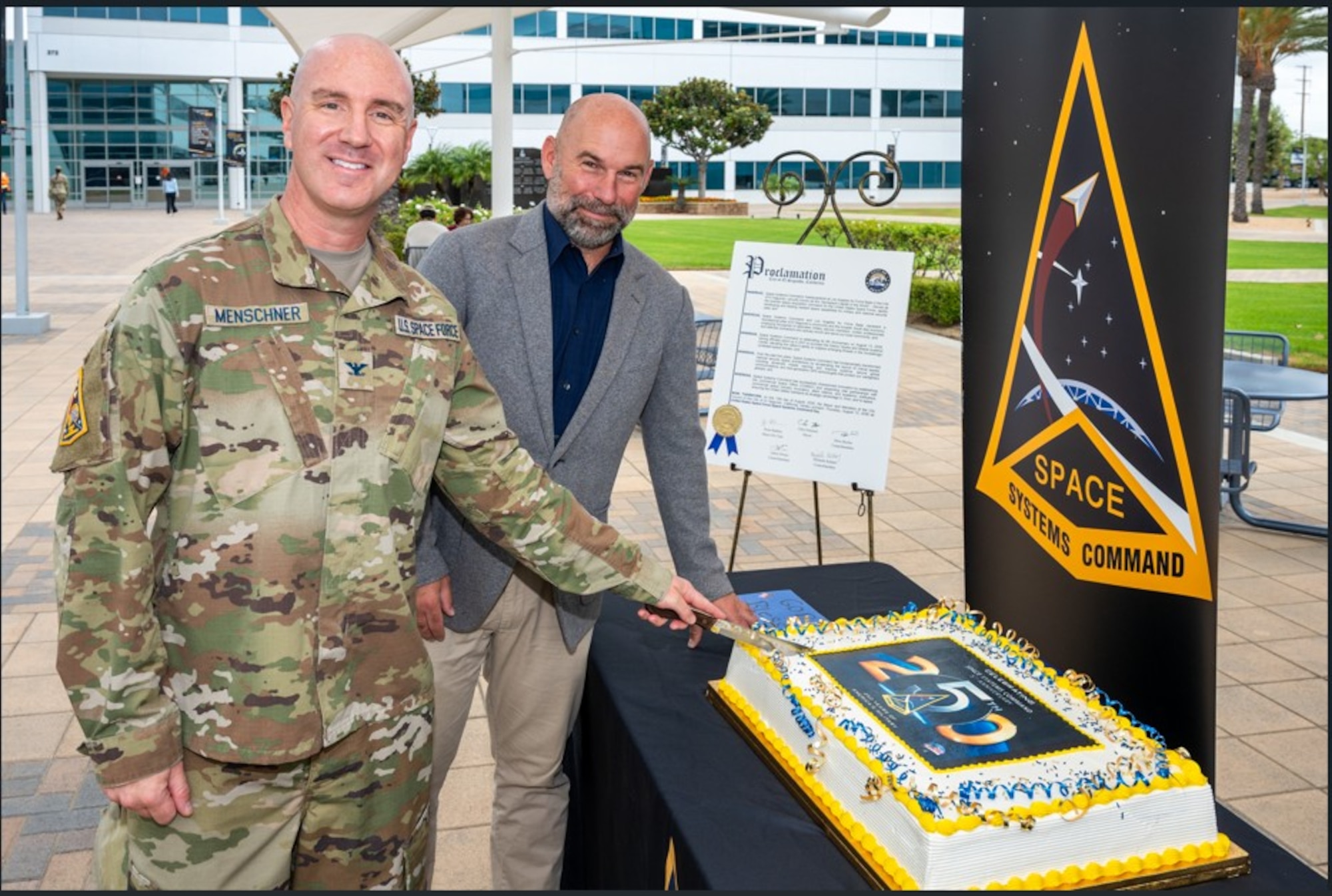 From left, USSF Col. Andrew Menschner, deputy commander, Space Systems Command (SSC), and Chris Pimentel, Mayor of El Segundo, Calif., participate in ceremonial cake cutting commemorating the 5th anniversary of SSC’s stand up as a U.S. Space Force Field Command on Aug. 13, 2026. SSC is the Nation’s premier space acquisition organization responsible for fielding space-based capabilities that protect our Nation’s interests in, from and to space. The command is headquartered at Los Angeles Air Force Base in El Segundo, Calif. with operating locations throughout the country including space launch operations at Cape Canaveral Space Force Station and Patrick Space Force Base in Fla. and Vandenberg Space Force Base in Calif. (U.S. Space Force Photo by Chris Kim, USSF)