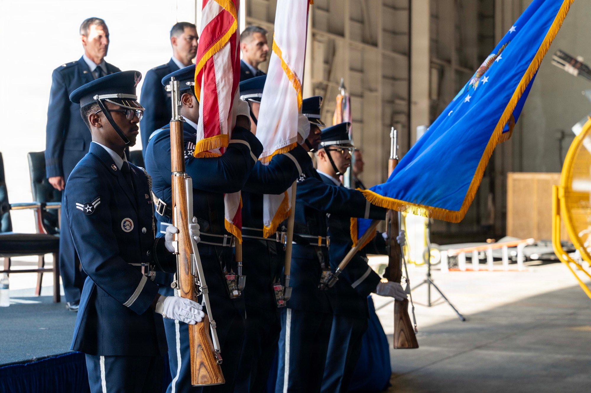 U.S. Air Force Airmen assigned to the 18th Wing Base Honor Guard Team present the colors during a change of command