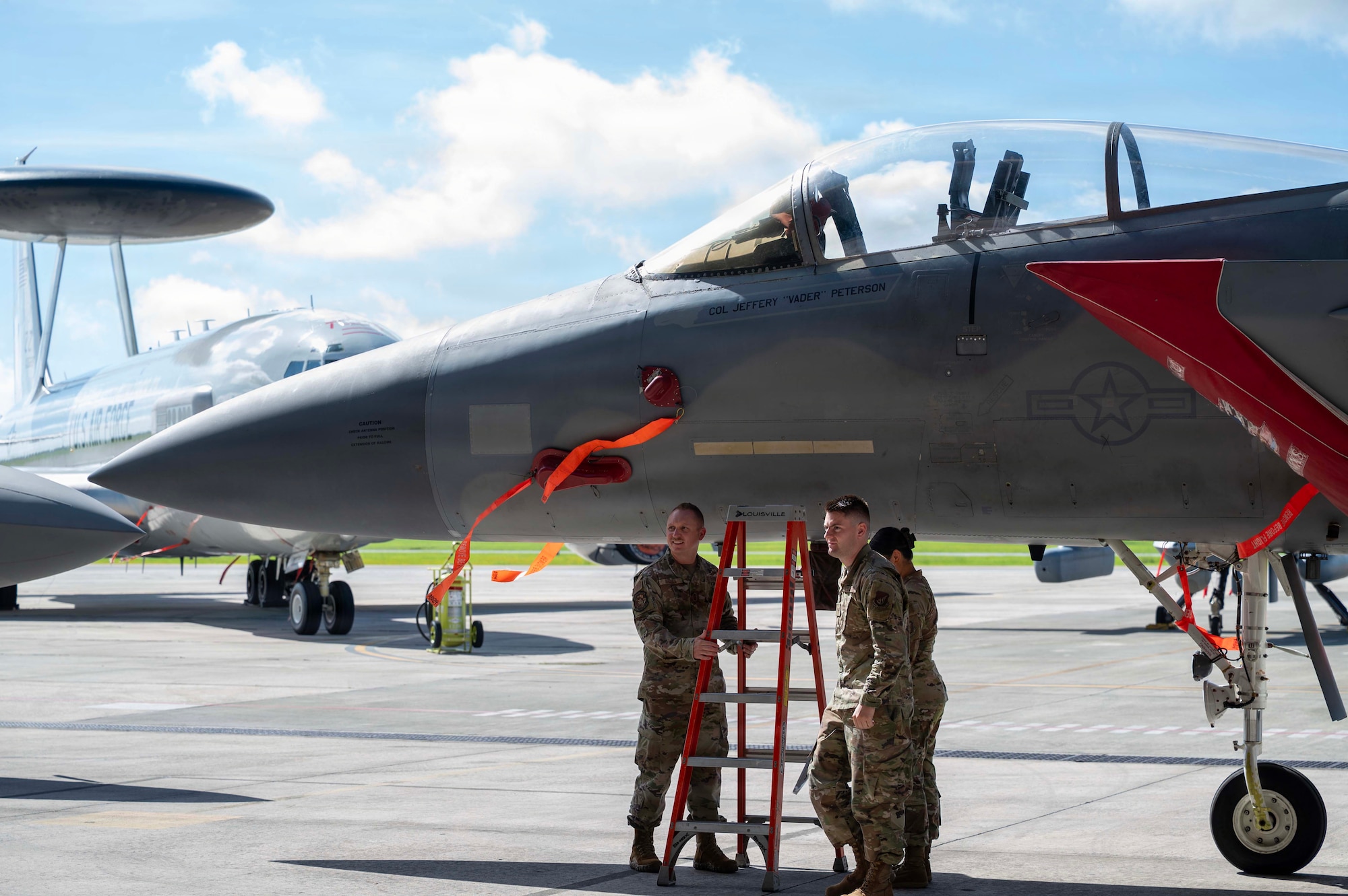 U.S. Air Force Airmen assigned to the 18th Operations Group change the commander’s name on an F-15E Strike Eagle