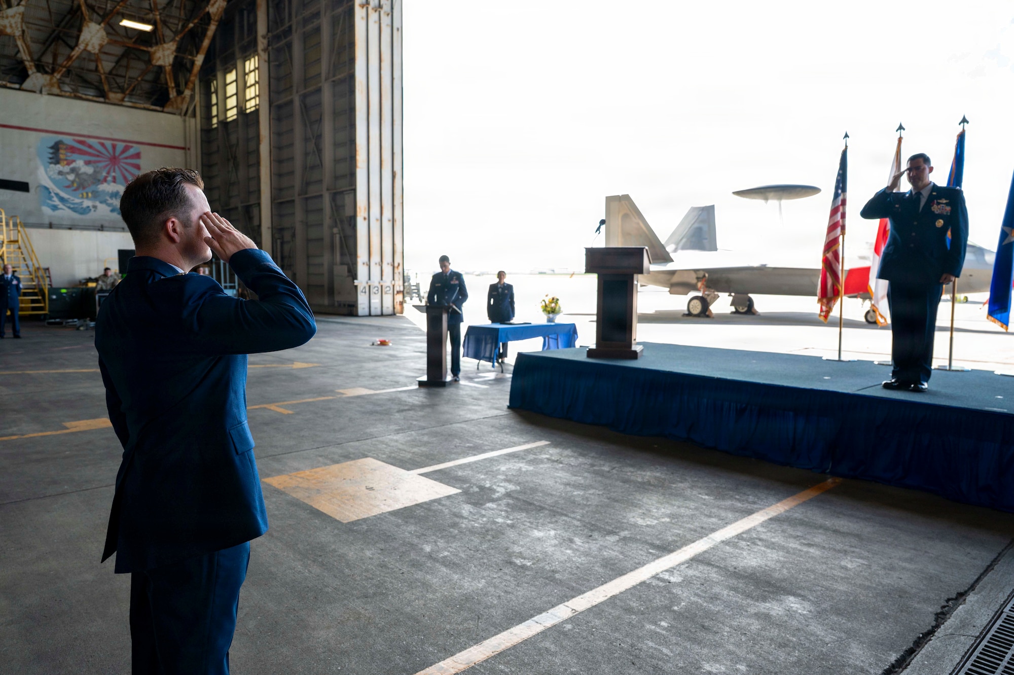 U.S. Air Force Col. David Deptula, right, outbound 18th Operations Group commander, renders a final salute to the 18th OG