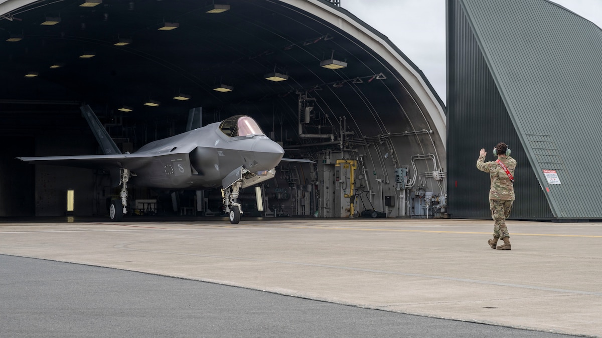 U.S. Air Force Airman Grace Christensen, 35th Aircraft Maintenance Squadron F-35A Lightning II crew chief, directs an F-35 piloted by Col. Oliver Lause, 35th Fighter Wing commander, out of a hardened aircraft shelter at Misawa Air Base, Japan, July 29, 2026.