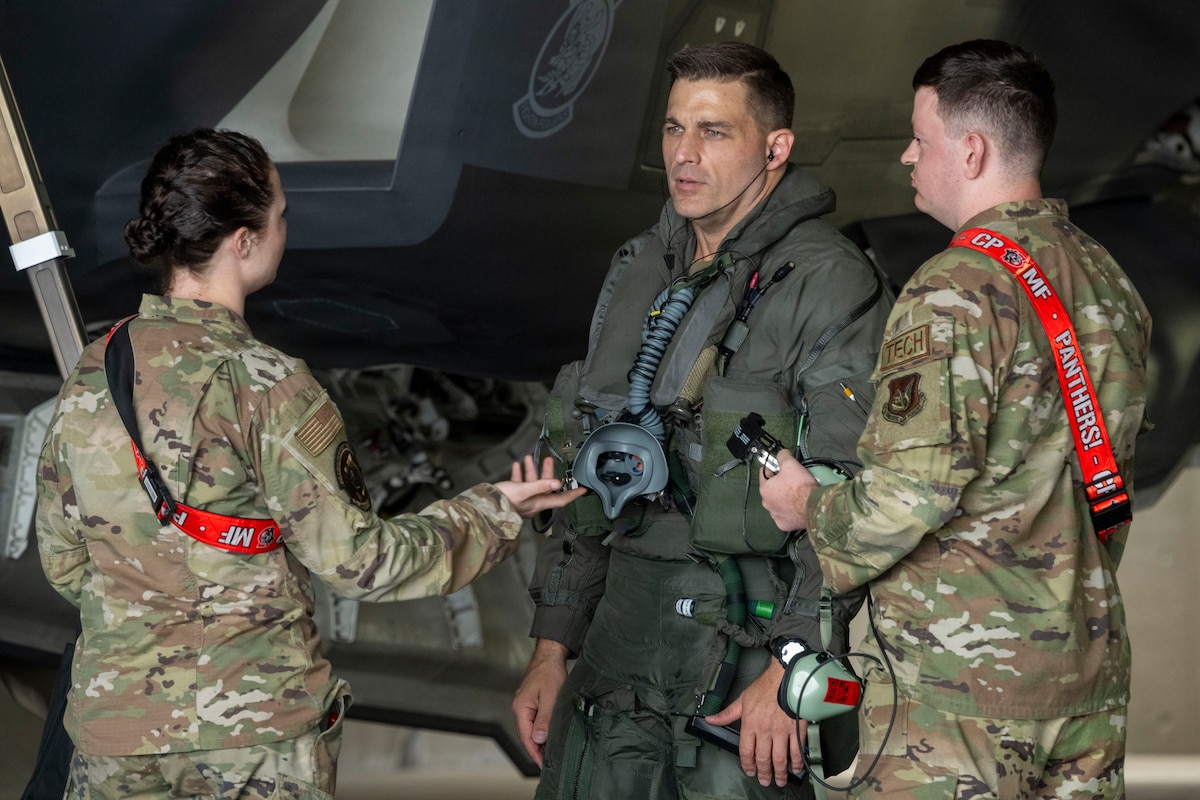 U.S. Air Force Airman Grace Christensen, left, 35th Aircraft Maintenance Squadron (AMXS) F-35A Lightning II crew chief, Col. Oliver Lause, center, 35th Fighter Wing (FW) commander, and Senior Airman James Stewart, 35th AMXS F-35 avionics specialist, discuss flight preparation prior to an F-35 flight at Misawa Air Base, Japan, July 29, 2026.