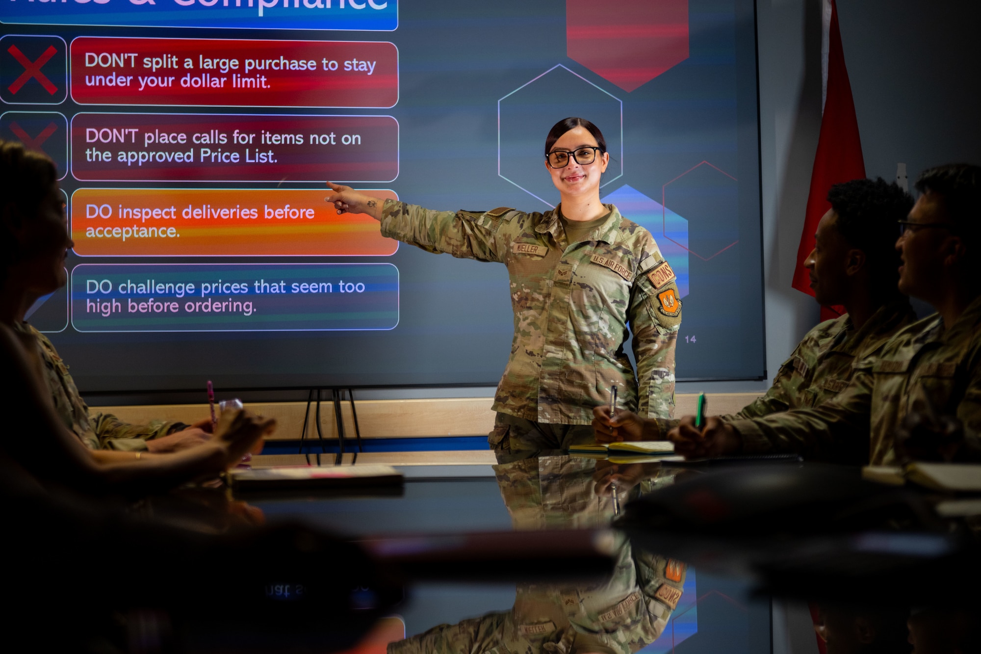 A woman in uniform briefs a class.