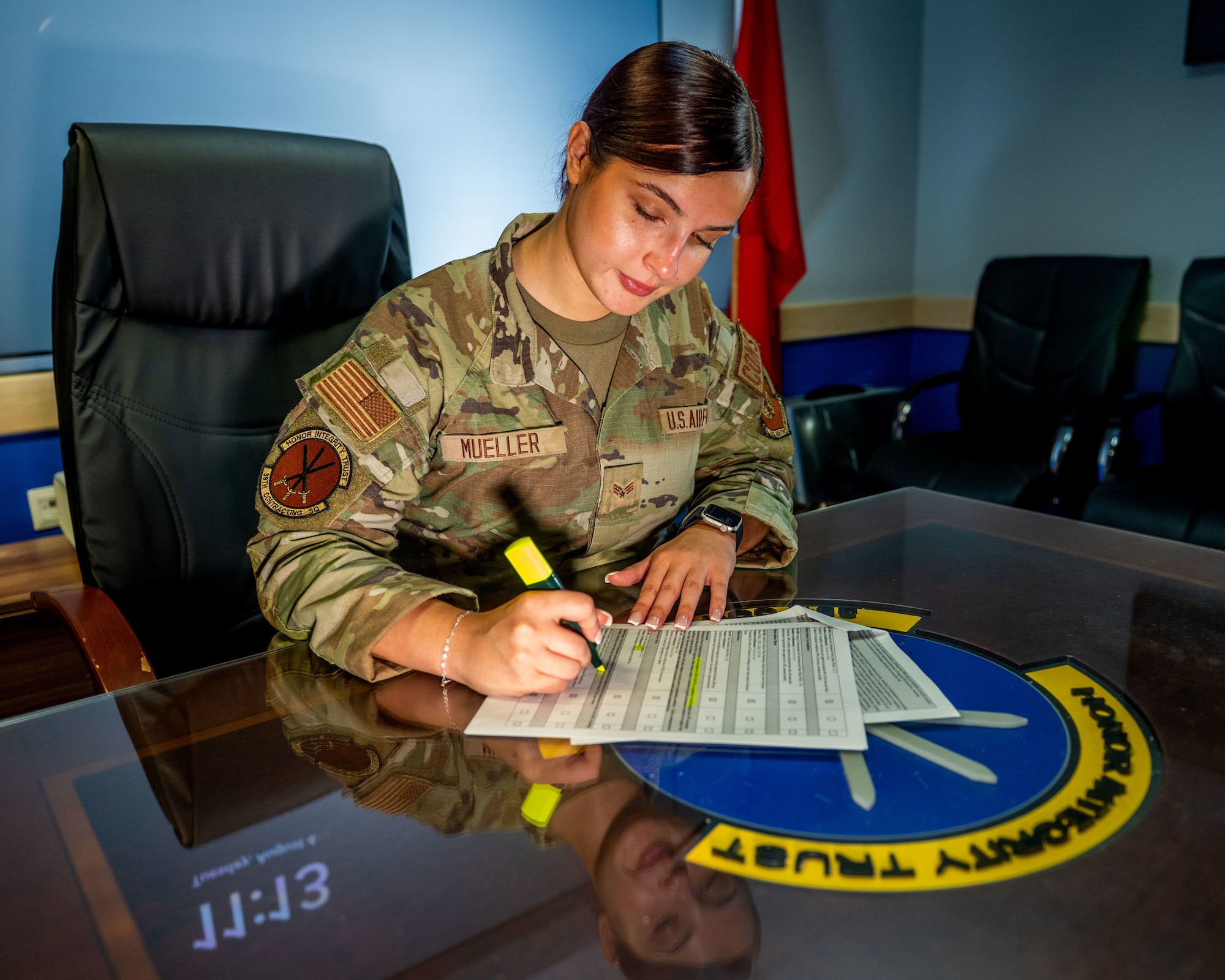A woman writes at a table.