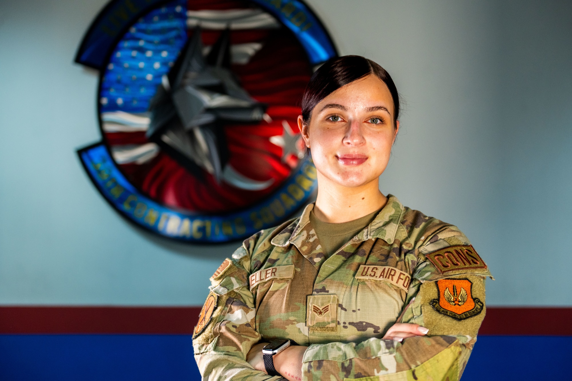 A woman in uniform stands for a portrait.