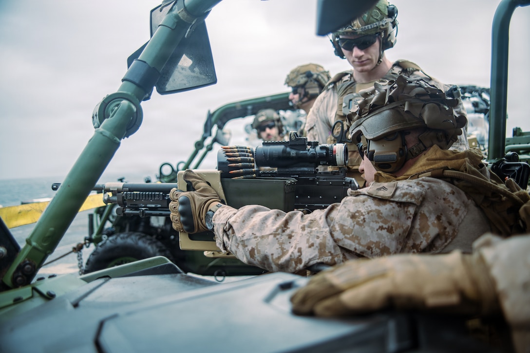 U.S. Marines with Weapons Company, Battalion Landing Team 3/5, 11th Marine Expeditionary Unit, conduct an M240B machine gun live-fire range on the flight deck of San Antonio-class amphibious transport dock USS Portland (LPD 27) in the U.S. Central Command area of responsibility, August 14, 2026. (U.S. Marine Corps photo by Cpl. Avery Wayland)