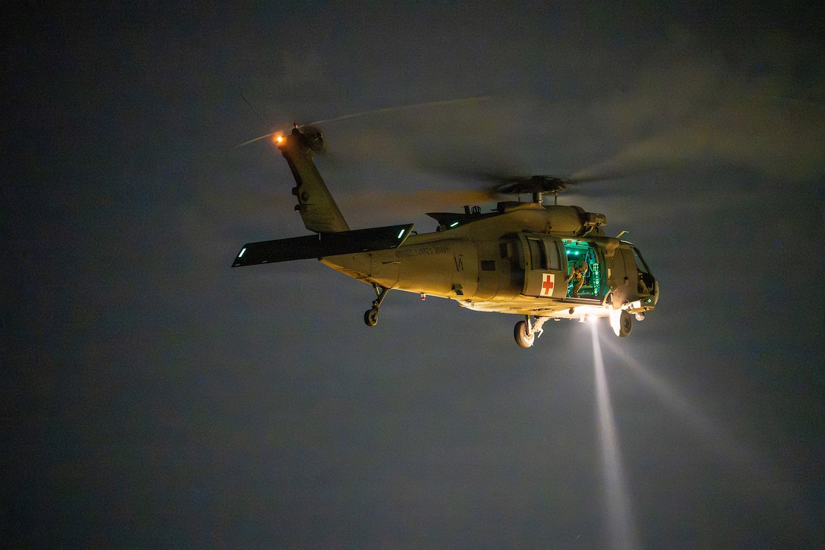 An Alabama Army National Guard UH-60 Black Hawk helicopter conducts nighttime medical evacuation training during Operation Tuskegee Thunder at Dannelly Field, Alabama, Aug. 13, 2026.