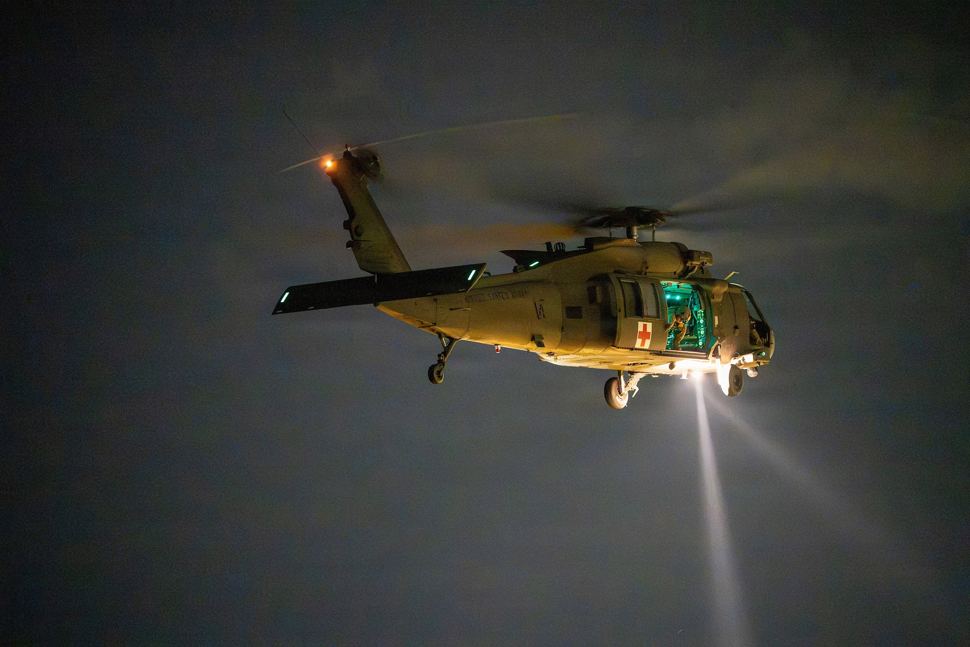 An Alabama Army National Guard UH-60 Black Hawk helicopter conducts nighttime medical evacuation training during Operation Tuskegee Thunder at Dannelly Field, Alabama, Aug. 13, 2026.