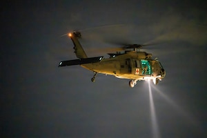 An Alabama Army National Guard UH-60 Black Hawk helicopter conducts nighttime medical evacuation training during Operation Tuskegee Thunder at Dannelly Field, Alabama, Aug. 13, 2026.