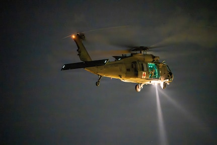 An Alabama Army National Guard UH-60 Black Hawk helicopter conducts nighttime medical evacuation training during Operation Tuskegee Thunder at Dannelly Field, Alabama, Aug. 13, 2026.
