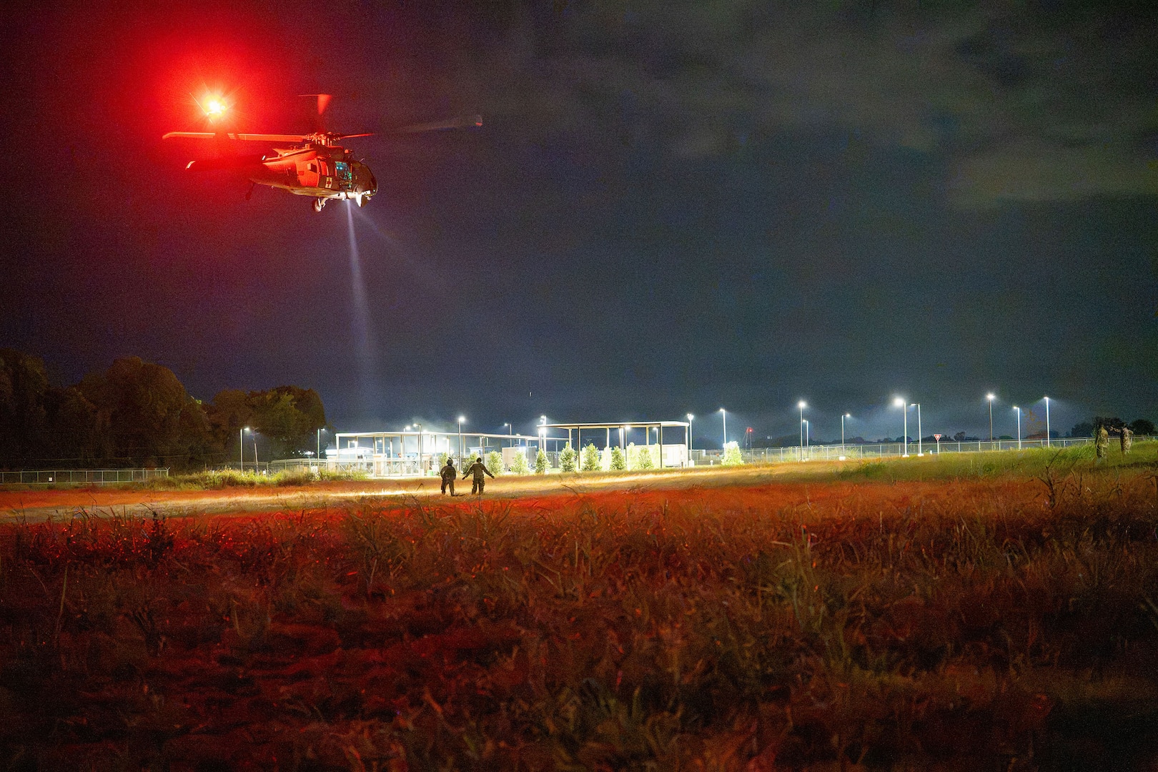 An Alabama Army National Guard UH-60 Black Hawk helicopter conducts nighttime medical evacuation training during Operation Tuskegee Thunder at Dannelly Field, Alabama, Aug. 13, 2026.