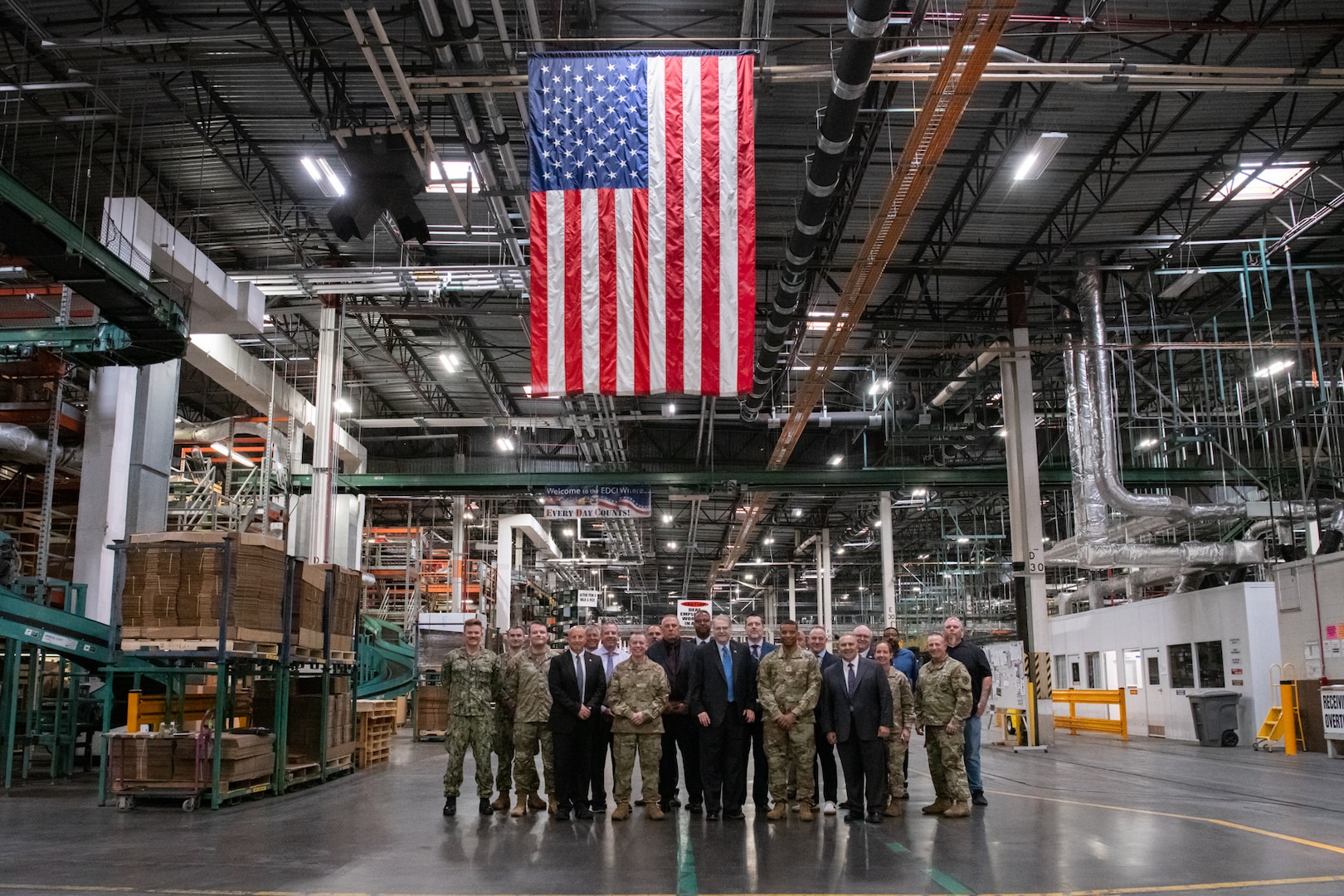People posing for a photo in a warehouse.