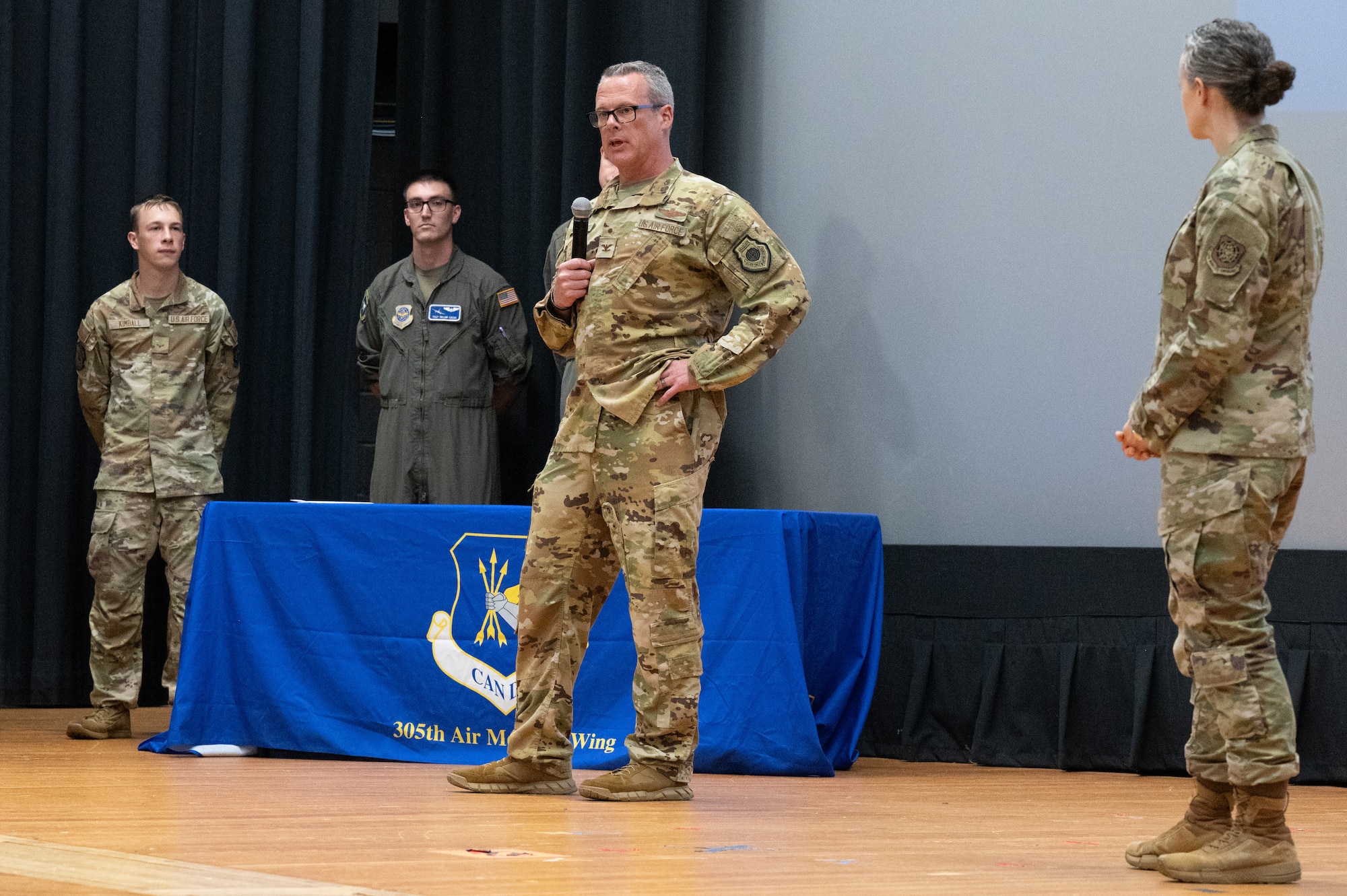 U.S. Air Force Col. Allen Morris, center, 305th Air Mobility Wing commander, speaks to the audience during an all call at Joint Base McGuire-Dix-Lakehurst, N.J., Aug. 10, 2026.