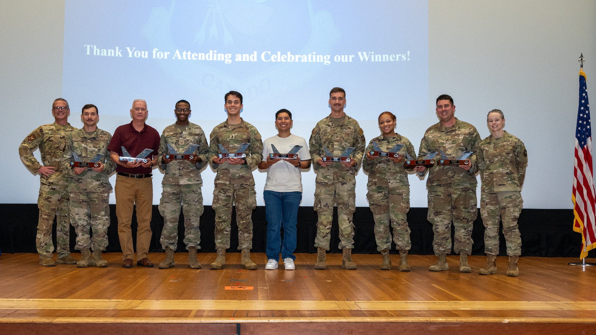 Quarterly Award winners from the 305th Air Mobility Wing display their trophies along with U.S. Air Force Col. Allen Morris, far left, 305th AMW commander, and Chief Master Sgt. Tiffany Sargent, far right, 305th AMW command chief, during the Second Quarter Awards Ceremony at Joint Base McGuire-Dix-Lakehurst, N.J., Aug. 10, 2026.