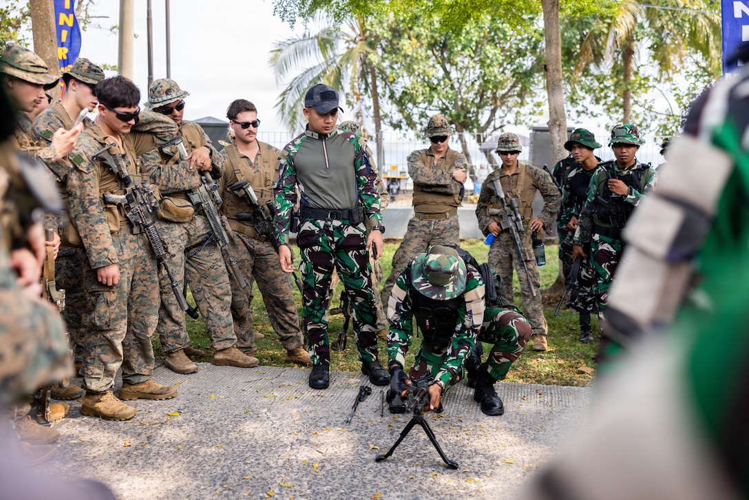 U.S. Marines with Alpha Company, 1st Battalion, 5th Marine Regiment, Marine Rotational Force – Darwin 26, observe Indonesian marines with 7th Infantry Battalion, 4th Brigade, break down a Pindad SM-2 general-purpose machine gun as part of a platoon exchange at the Indonesian Marine Corps 9th Battalion base near Lampung, Indonesia, Aug. 14, 2026.