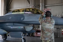 Gen. Gregory Guillot, commander of the North American Aerospace Defense Command (NORAD) and U.S. Northern Command (USNORTHCOM), is marshaled into a hangar after riding in an F-16 Fighting Falcon during a visit at Eielson Air Force Base, Alaska, Aug. 13, 2026. Guillot visited the wing to meet with leaders and Airmen, fly with the 354th Fighter Wing, and discuss the critical importance of the Alaskan NORAD region and its mission of homeland and North American defense. (U.S. Air Force photo by Senior Airman Nicholas Paczkowski)