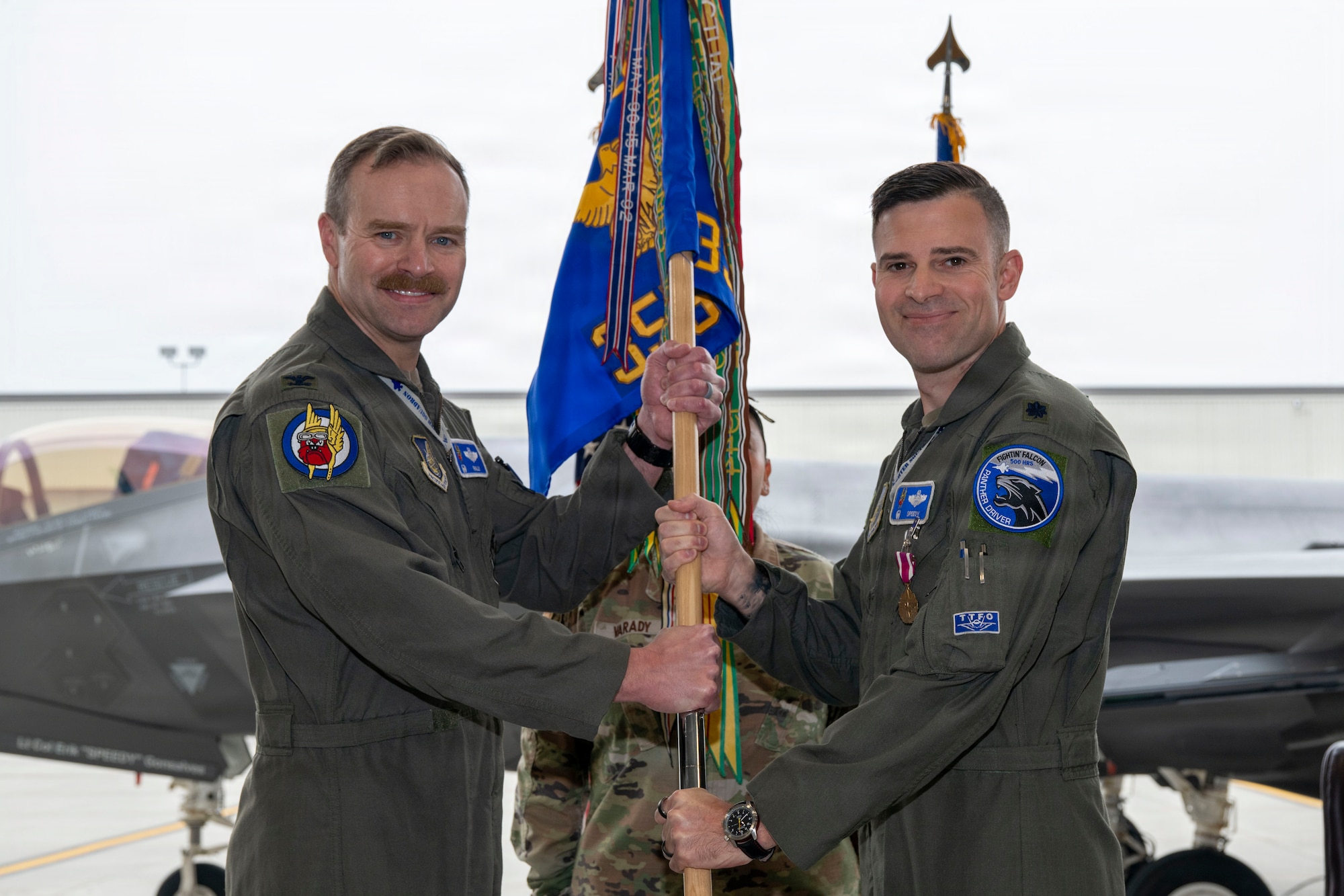 U.S. Air Force Lt. Col. Erik Gonsalves, right, relinquishes command of the 355th Fighter Squadron to U.S. Air Force Col. Samuel Chipman, 354th Operations Group commander, during a change of command ceremony at Eielson Air Force Base, Alaska, Aug. 14, 2026.